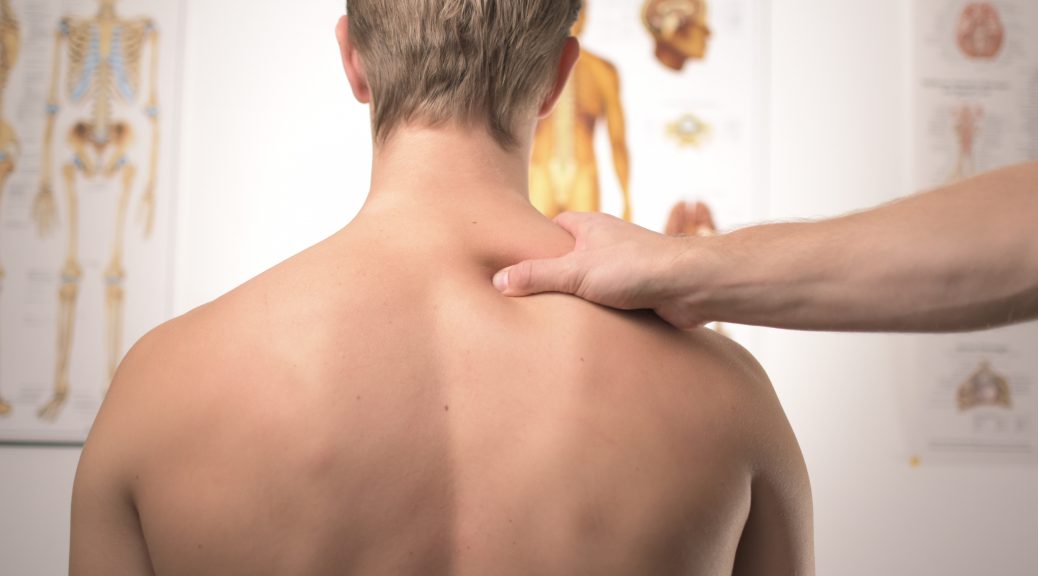 reasons to see a chiropractor - hand massaging man's back in a chiropractor's practice